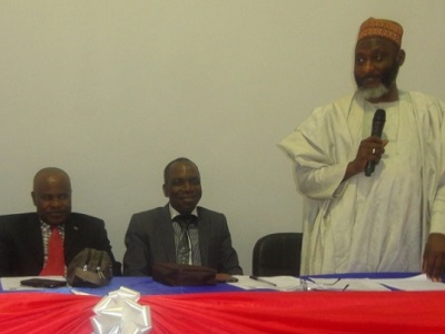 Dr. Ashiru Sani Daura, acting director general, National Information Technology Development Agency (NITDA) (standing) making remarks at the workshop while Professor David Adewumi and others listen.